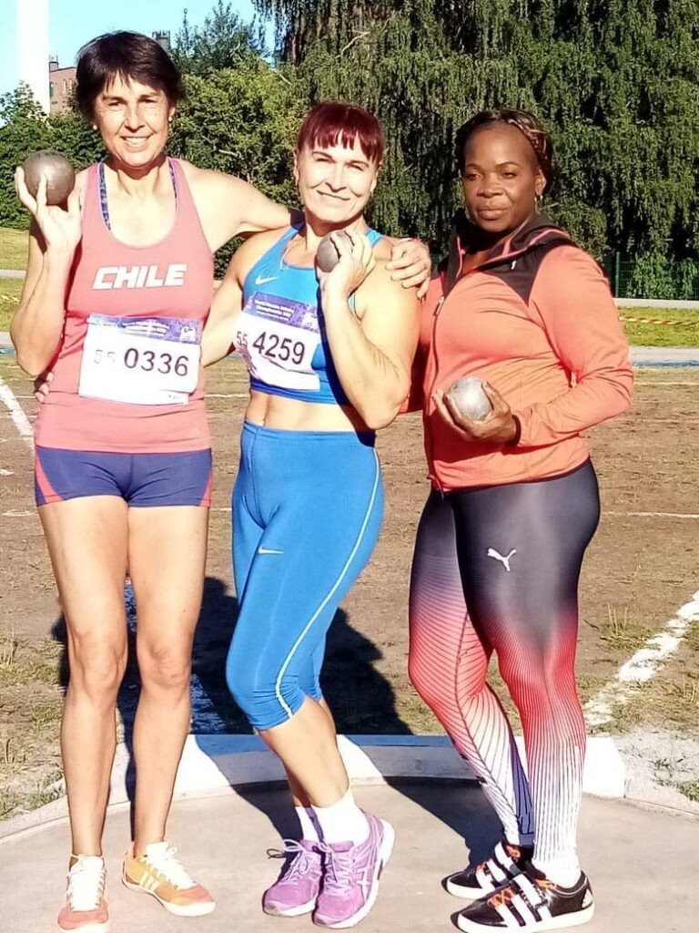 Trinidad and Tobago's Gwendolyn Smith, right, after earning silver in the women's 55-59 shot put at the World Masters Championships in Finland on Thursday. At centre is Ukranian gold medallist Svitlana Sorochuk and left, bronze receiver Chilean Marcela Barrientos.  - Courtesy: Karibelle Sports