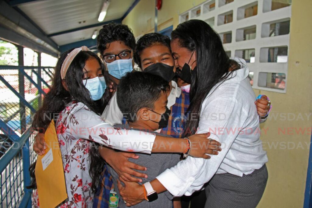 Cancer patient Sidara Akalloo of Grant Memorial Presbyterian School, is embraced as she got her SEA first choice of Naparima Girls' High School on Friday. - Photo by Marvin Hamilton
