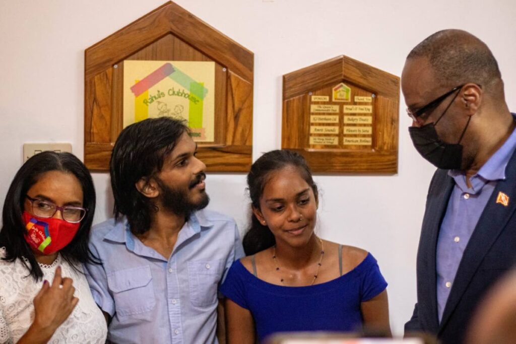  Rahul unveiling a plaque at the opening of Rahul's Clubhouse along with his sister Maya, Sen Paul Richards and Dr Radica Mahase. - courtesy Dean Matthew Cruz