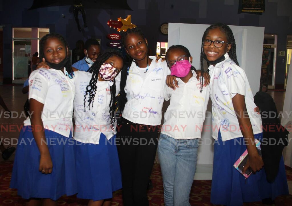 Pupils from St Agnes Primary School, from left, Malaysia Cameron, Kyla Long, Tahira Phillip, Stacian Wilson and Jayla Prentice, enjoyed each other's company at MovieTowne, Port of Spain, on Friday after receiving their SEA results. - ROGER JACOB