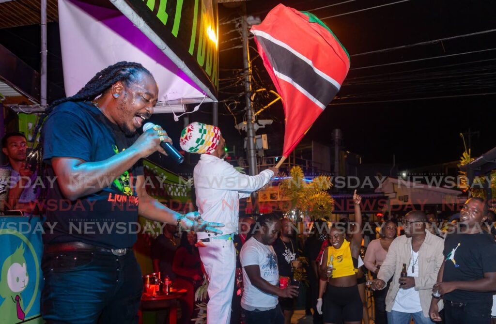 Reggae artiste Isasha, left, performs in Tobago recently. - David Reid