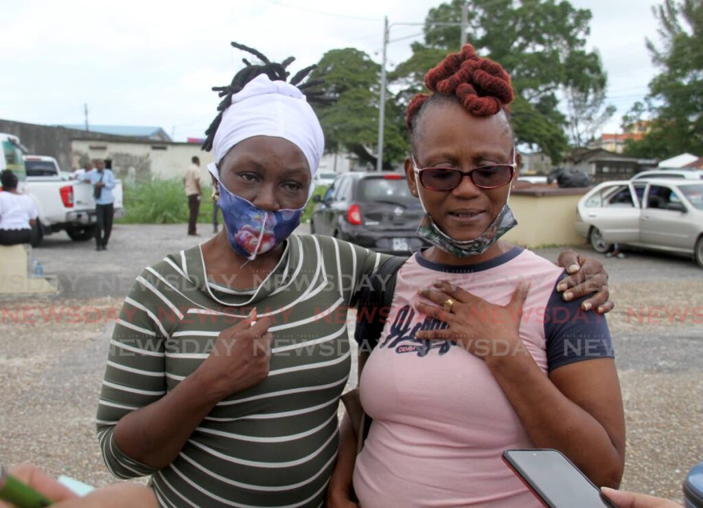 Nicole Richards, mother of Fabien Richards, and Michelle John, grandmother of Isaiah Roberts, speak with reporters at the Forensic Science Centre in St James on Monday. - AYANNA KINSALE