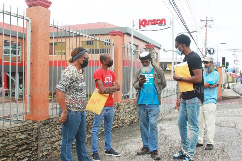 Current and former workers of Kenson Operational Services Ltd protest outside the company's gates at Lady Hailes Avenue, San Fernando on Tuesday.  Photo by Lincoln Holder