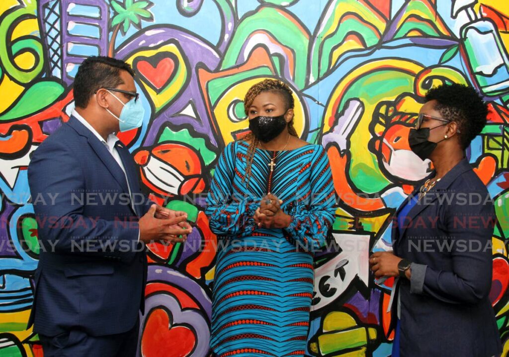 Minister of Education Nyan Gadsby-Dolly, centre, speaks with Amcham CEO Nirad Tiwarie and head of branding and marketing at First Citizens, Gillian Benjamin, at the launch of the Mural in Schools Project, Education Towers,  Port of Spain, on Monday. - Photo by Ayanna Kinsale