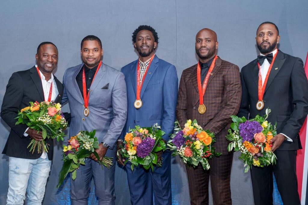 GOLD AT LAST: Trinidad and Tobago’s 2008 4x100 men’s relay team (from left) Aaron Armstrong, Keston Bledman, Emmanuel Callender, Marc Burns and Richard Thompson with their 2008 Beijing Olympic gold 
medals which were reallocated to them on Tuesday at a ceremony in Lausanne, Switzerland. - 