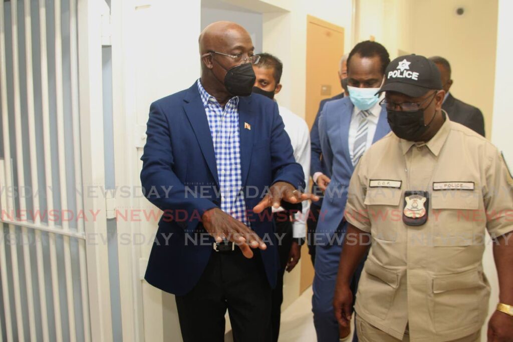 Prime Minister Dr Keith Rowley and acting Police Commissioner Mc Donald Jacob during a tour of St Clair Police Station, on Friday.  - ROGER JACOB