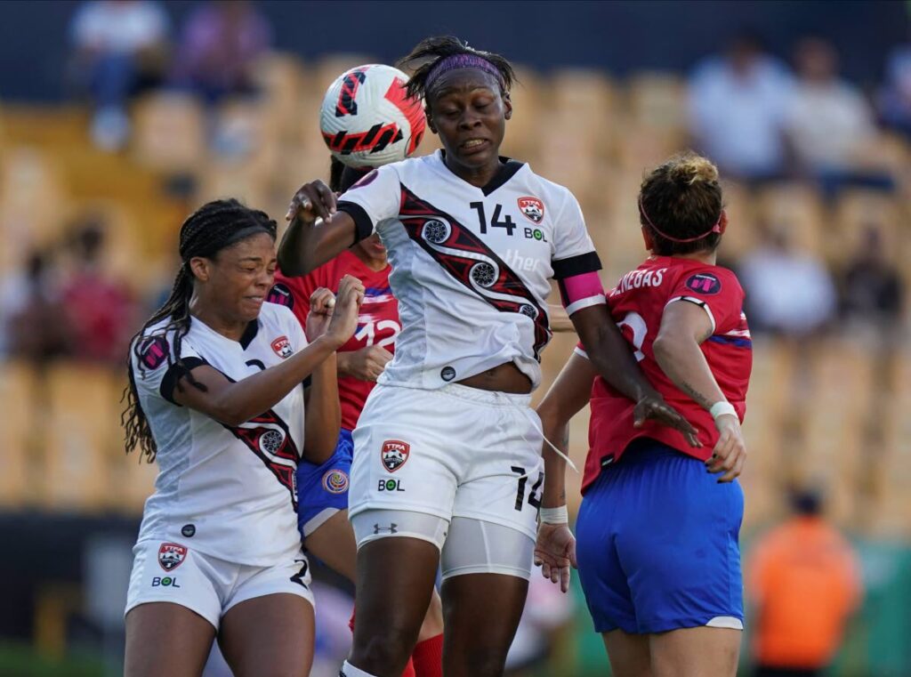 Trinidad and Tobago's Karyn Forbes, centre, and Costa Rica's Carolina Vanegas, right, jump to head a ball during a CONCACAF Women's Championship match in Monterrey, Mexico, on Friday, . (AP Photo) - 