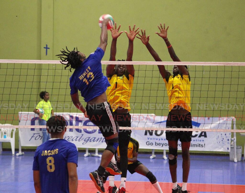 Ajani Henley (#13) from the US Virgin Islands hits a shot through the Jamaican defensive line during the teams' men's Under-21 match at the CAZOVA Youth Championship, on Saturday, at the Southern Indoor Sports Arena, Pleasantville. - ROGER JACOB