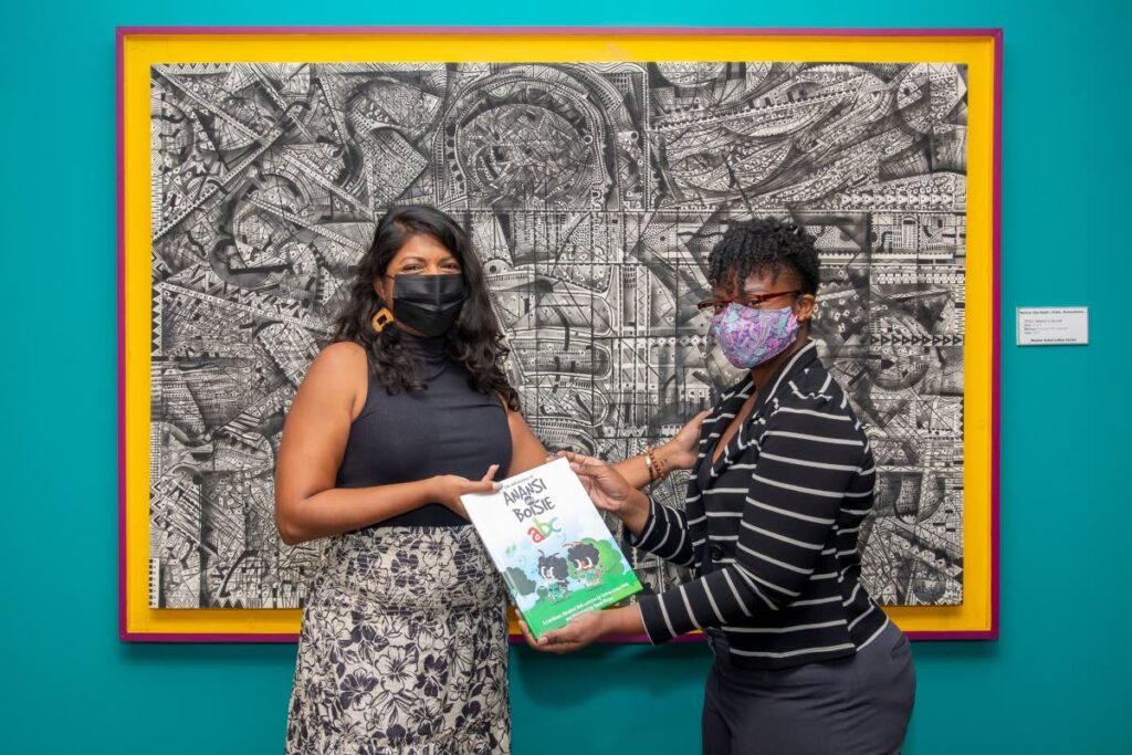  Farrah Chow Quan, left, presents a copy of the book to a representative of the National Library and Information System Authority (Nalis) on July 4. - 