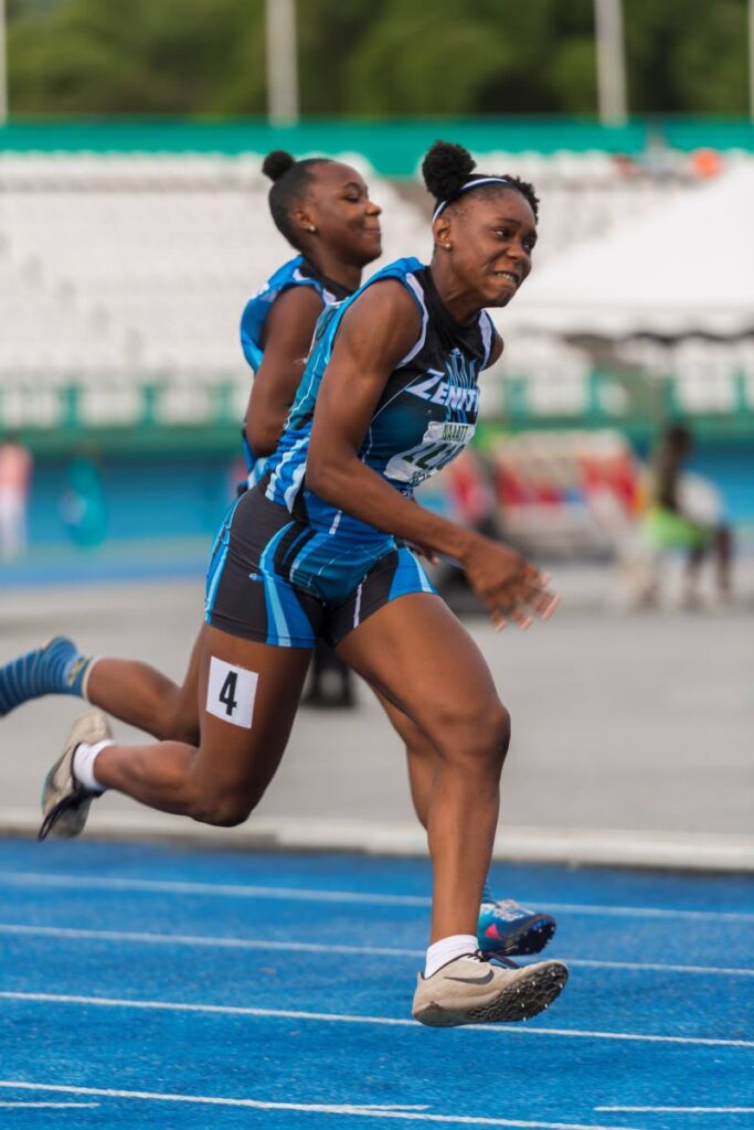 Zenith's Dextra Harris (L) passes the baton to teammate Alexxe Henry during the Girls' U20 4x100m relay, on Sunday, at the NGC/NAAA Junior Championships, at the Dwight Yorke Stadium, Bacelot.  - Photo by Dennis Allen for @TTGameplan