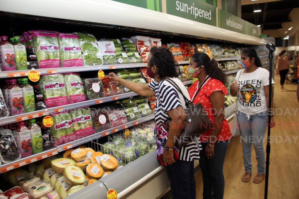 Customers browsing the vegetable section of the newly opened Massy Stores in San Juan. Photo by Sureash Cholai