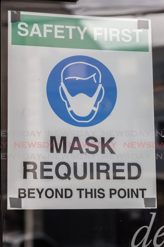 File photo of a face mask required sign - JEFF K MAYERS