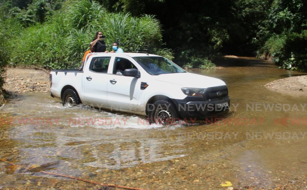 A pick-up truck crosses one of the rivers at Texas Trace, Rincon Road, Las Cuevas on July 13. Photo by Roger Jacob