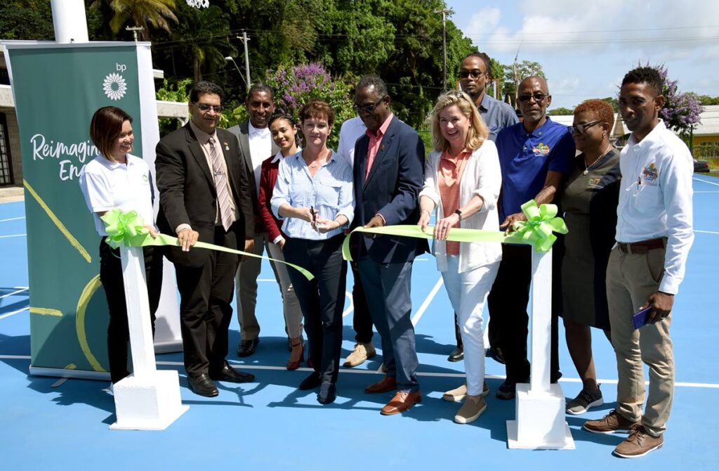 bpTT regional president Claire Fitzpatrick cuts the ribbon to open the newly refurbished basketball and tennis courts at the Mayaro Resource Centre on July 7. Looking on are Mayaro MP Rushton Paray (second from left) and senior vice president bp Americas, communications and advocacy, Mary Streett (fourth from right). - Courtesy bpTT