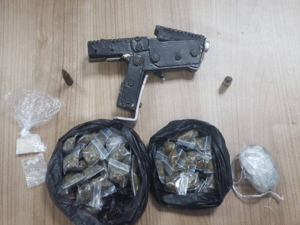 SEIZED ITEMS: The homemade pistol, ammunition and packets of compressed marijuana seized by Northern Division police in two separate anti-crime exercises on Thursday night. PHOTO COURTESY TTPS - 