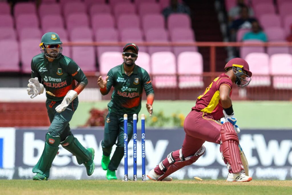 Nicholas Pooran (right) of West Indies is bowled by Nasum Ahmed as Quazi Nurul Hasan Sohan (left) and Liton Das (centre) of Bangladesh celebrate during the 2nd ODI match between West Indies and Bangladesh at Guyana National Stadium in Providence, Guyana, on Wednesday. (AFP PHOTO) 