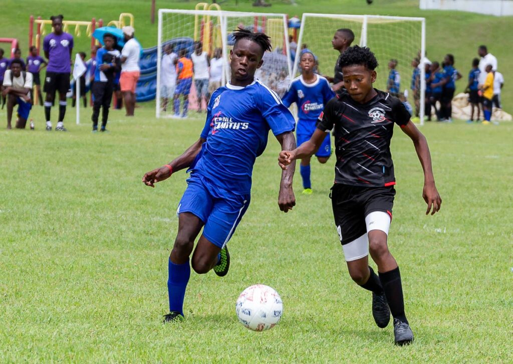 Ball Blasterz’ Malachi Peters, left,and Cox Football Academy’s Keon De La Rosa battle for possession during the boys’ under 15 match, on Saturday, at the 7vs7 Football Tournament at Speyside Recreation Grounds. The tournament was hosted by Kennya ‘Yaya’ Cordner. - David Reid