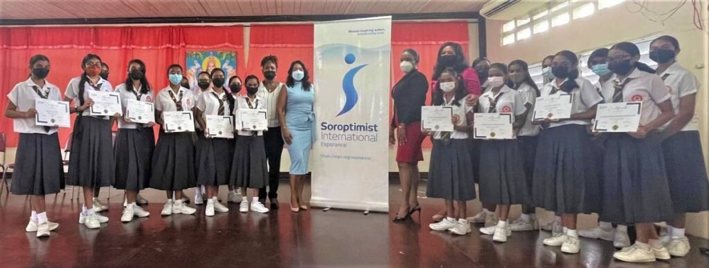Students from Parvati Girls’ Hindu College, Debe, show off certificates for participating in Soroptimist International Esperance’s Etiquette 101 programme. Soroptimist Marsha Marchan, in red and black was facilitator of the Etiquette 101 programme. - 