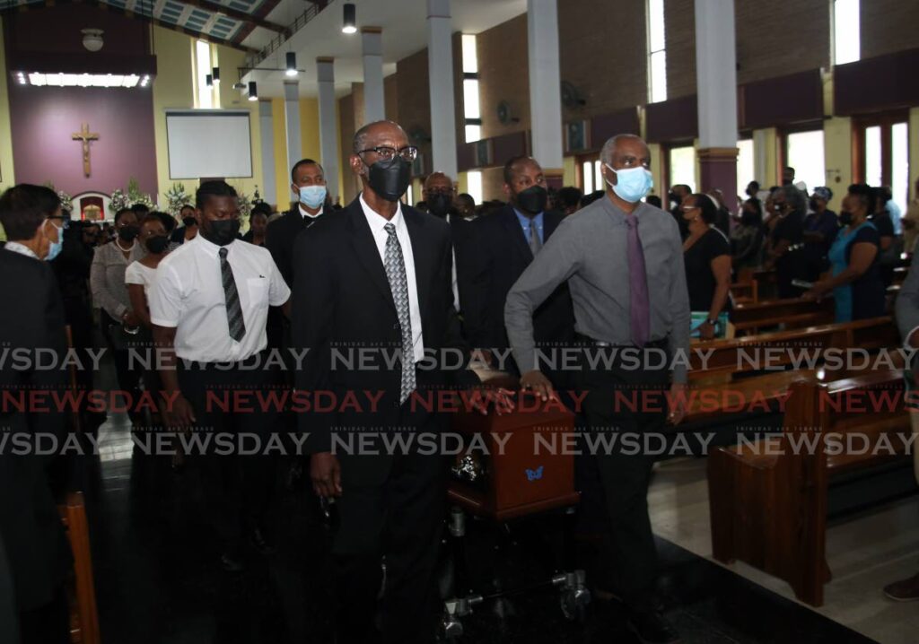 Pallbearers carry the casket of Anthony Harris at his funeral at St Finbar’s RC Church, Diego Martin, on Thursday. - Photo by Sureash Cholai