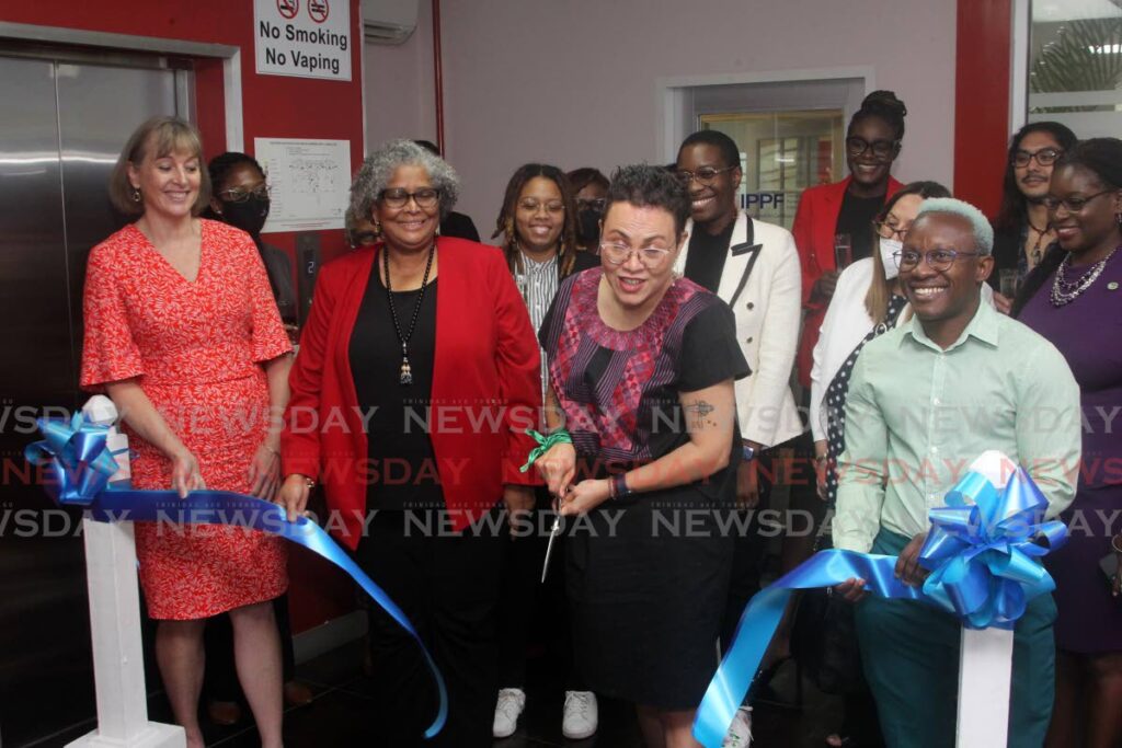 IPPF regional director Eugenia Lopez-Uribe, third from left, cuts the ribbon at the opening of the IPPF International Planned Parenting Federation,
Health Care Services Building, Trincity Industrial Park, Trincity, on Thursday as other IPPF officials and well-wishers look on. - ROGER JACOB