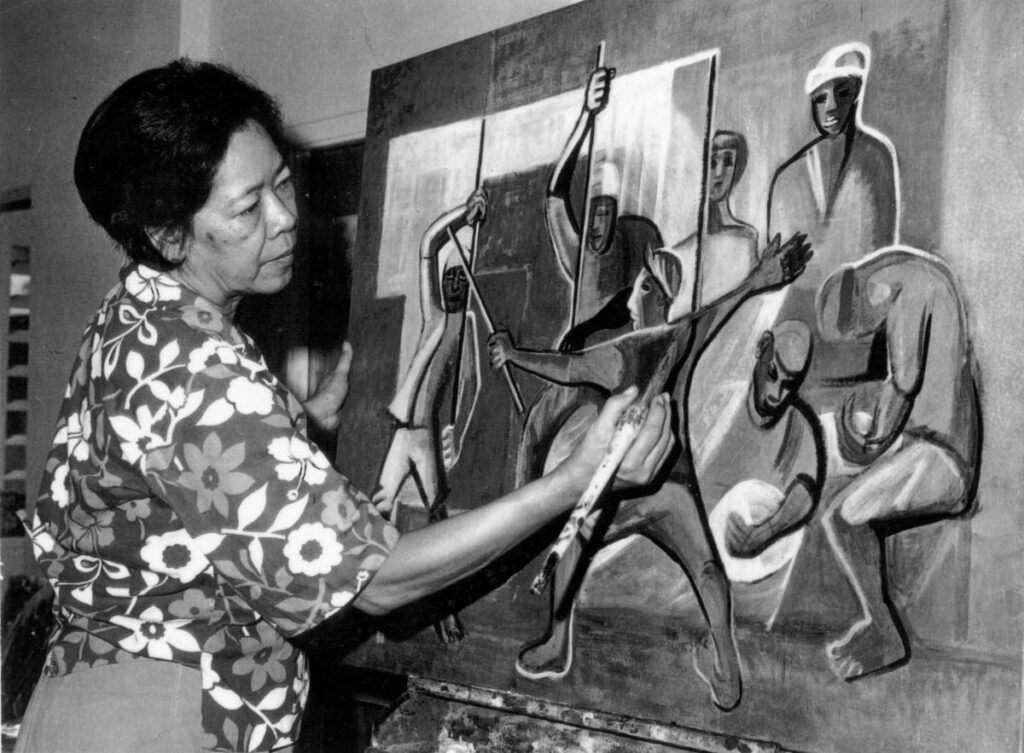 Sybil Atteck works on one of her paintings. - 