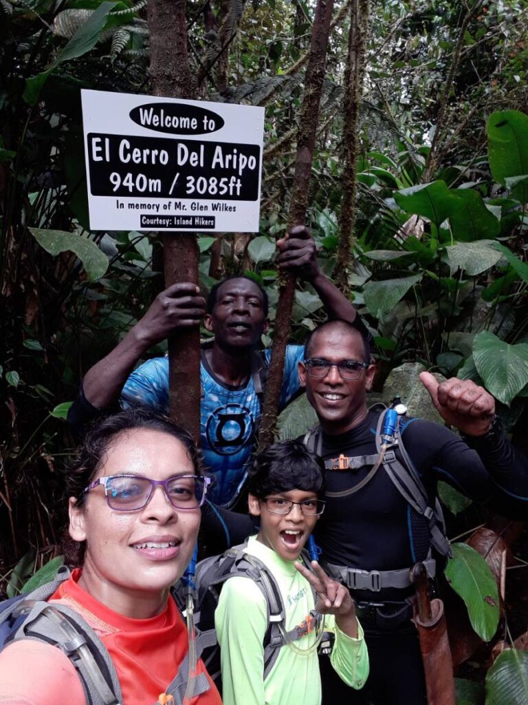 David Rampersad and his parents accompanied by another hiker on the El Cerro Del Aripo hiking trail. PHOTO COURTESY KELLY RAMPERSAD - 