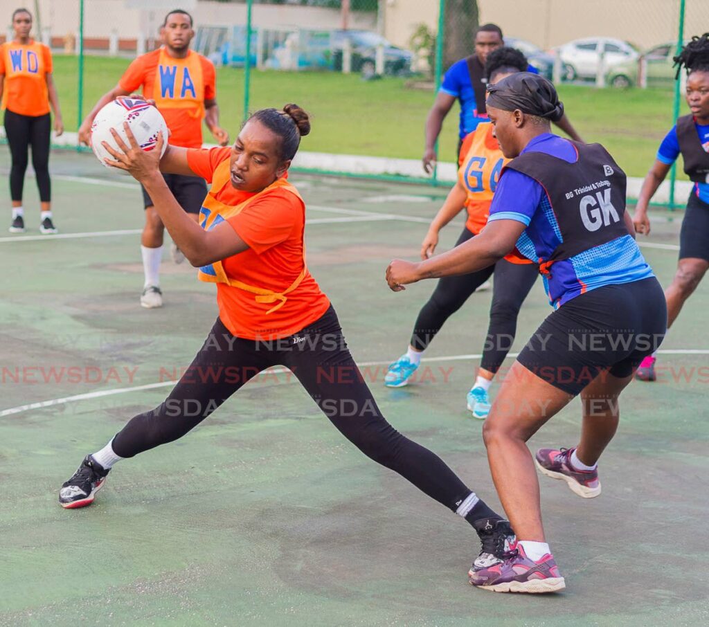 Rica Seeteran (centre) of Carenage is challenged by MIC Tigers goalkeeper Jamilah Nesbitt-Hope during their match on Thursday, in the RBL Laventille Netball League, at the Nelson Mandela Park Public Courts on Thursday. Seecharan scored 29 goals from 35 attemps as Carenage won the match 30-29. PHOTO BY DENNIS ALLEN FOR @TTGAMEPLAN. - 