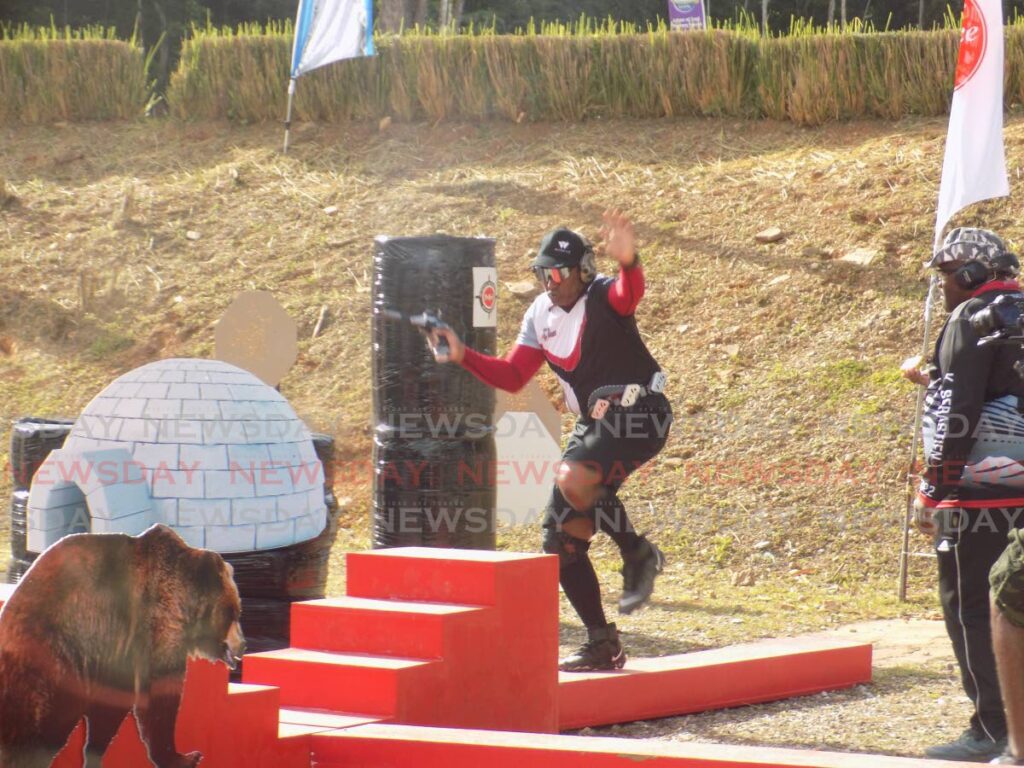 A Trinidadian sport shooter navigates obstacles in an event during the MH Tactical World Shoot tournament in Chaguaramas on Sunday.  - Shane Superville