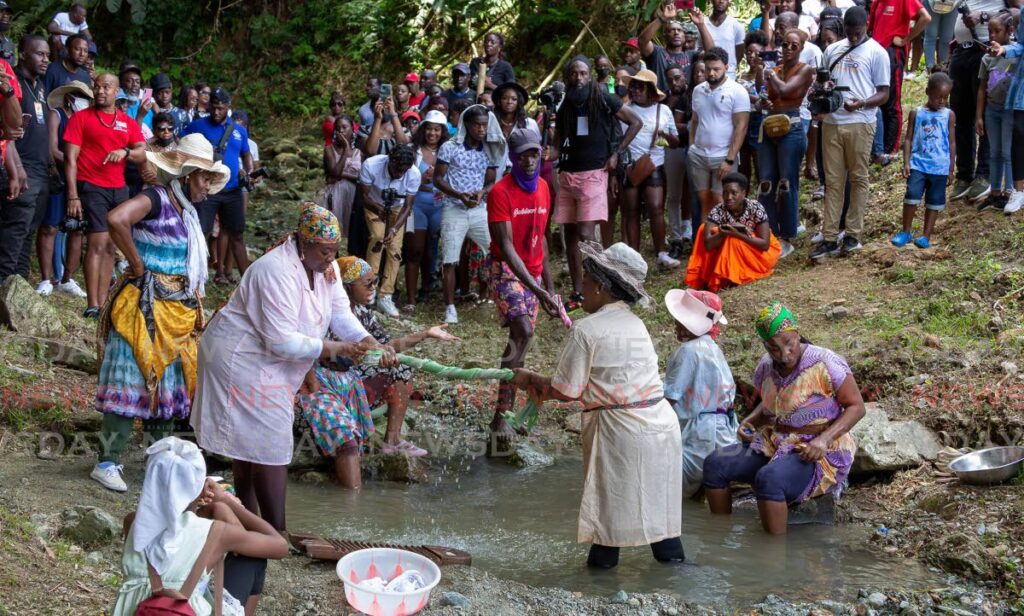 Charlotteville Folk Performers re-enact a riverside ritual where women in the village would wash the clothes of the recently deceased and tell stories. This took place at  Charlotteville Natural Treasures Day on Monday Photo by David Reid
