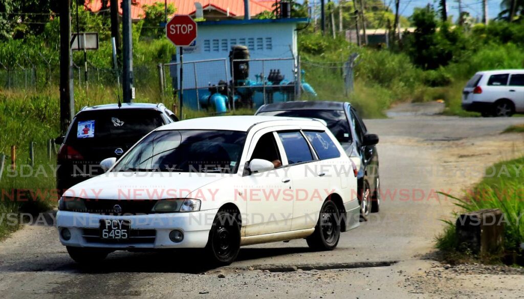 POTHOLE-VILLE: Dilapidated roads, such as this one in Longdenville, Chaguanas which had drivers in pain on Tuesday, was what led to several fiery protests in several parts of Trinidad including in Moruga and Cashew Gardens. PHOTO BY SUREASH CHOLAI - 