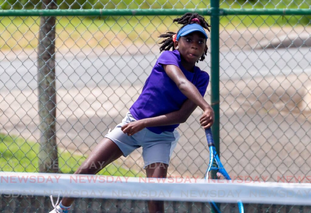 Cherdine Sylvester makes a return to her sister Charde Sylvester during the girls’ U14 match, during the RBC Tobago Junior Tennis Championships, Shaw Park, Tobago, on Tuesday.  - David Reid