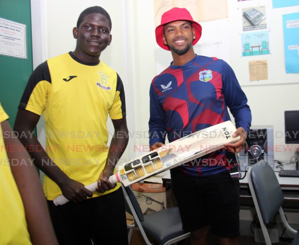 West Indies captain Nicholas Pooran (right) and Traquillity Secondary School team captain Rufano Stewart are pictured during a visit to the school by members of the West Indies cricket team, on Thursday, at  Victoria Avenue, Port of Spain. The West Indies play India in the first T20I, on Friday, at the Brian Lara Cricket Academy, Tarouba.  - SUREASH CHOLAI