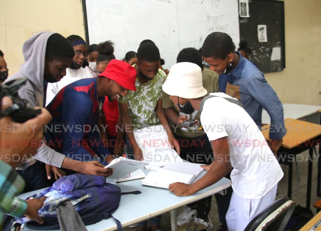 West Indies captain Nicholas Pooran signs autographs for students of the vacation revision camp at Tranquility Secondary School on Victoria Avenue in Port of Spain during a visit with some of his teammates. Photo by Sureash Cholai