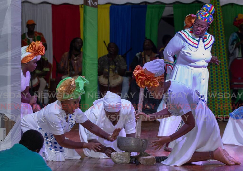 Members of the Pembroke Folk Performers re-enact, cooking on fireside for the crowds at Salaka Feast, Pembroke Village, Tobago. - DAVID REID