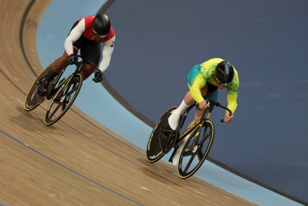 Matthew Richardson of Australi, right, and Nicholas Paul of Trinidad And Tobago compete in the men's sprint final during the Commonwealth Games track cycling at Lee Valley VeloPark in London, on Sunday. (AP Photo) - 