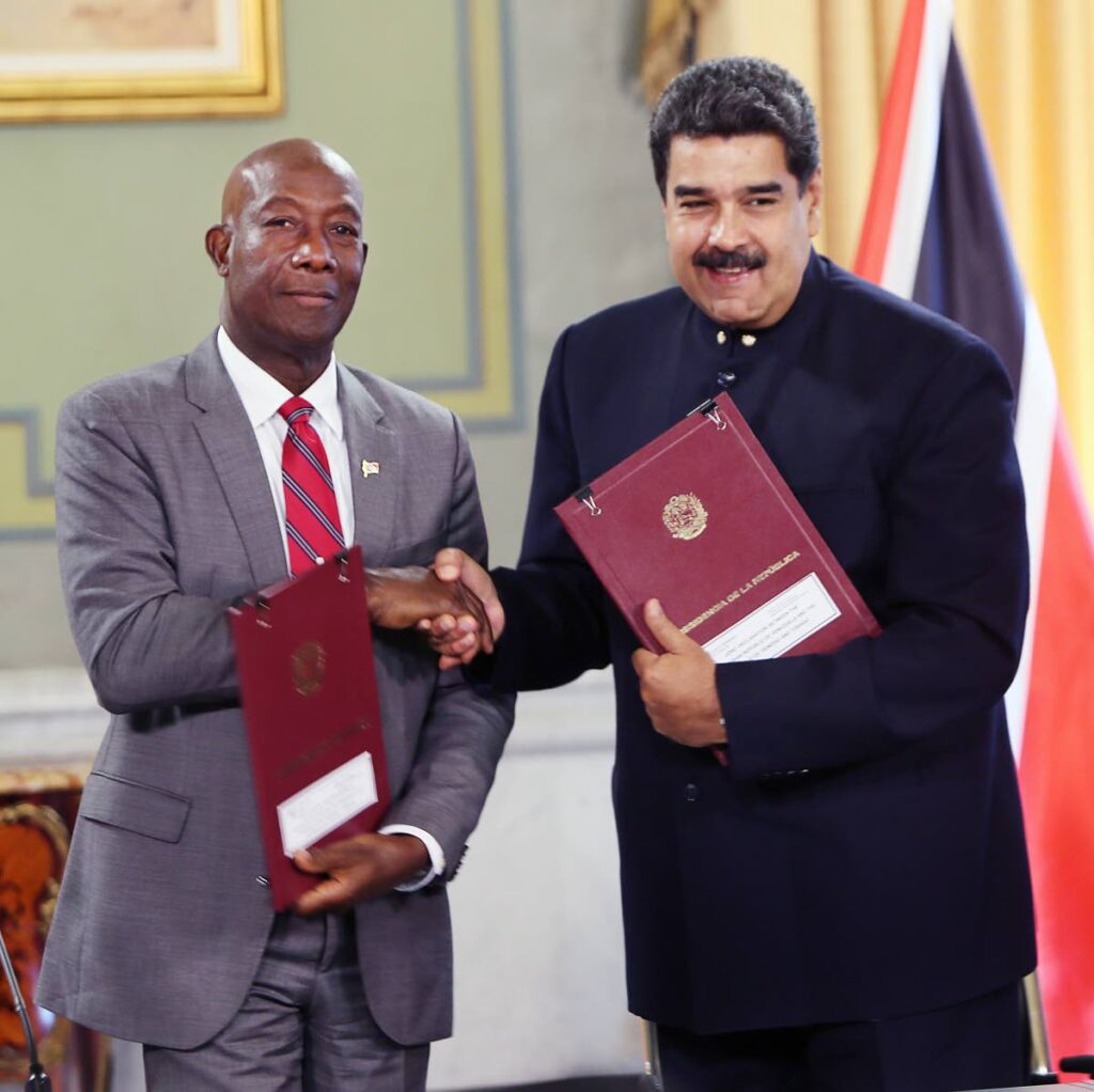 In this file photo, PM Dr Keith Rowley, left,  seals the deal with Venezuela's President Nicolas Maduro for the Dragon gas deal at the Presidential Palace, Caracas, Venezuela in 2018. - 