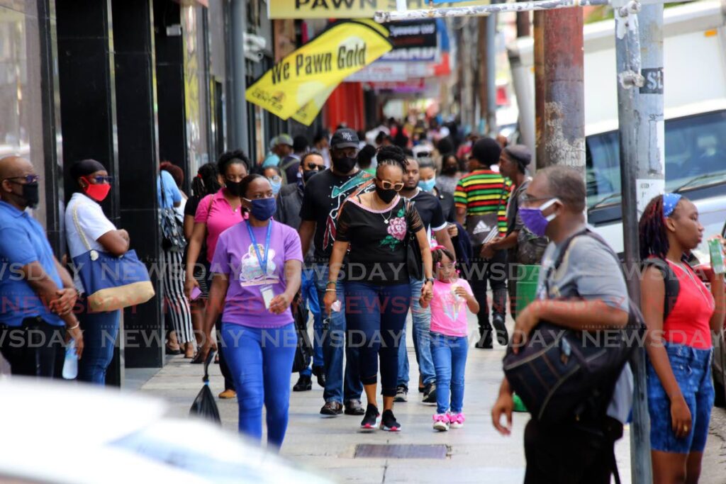 In this June 2020 photo, people go about their businesses in Port of Spain. While most observed the mask mandate and physical distancing recommendations at business places and government offices, on the streets, some seemed less inclined to do so. Photo by Sureash Cholai