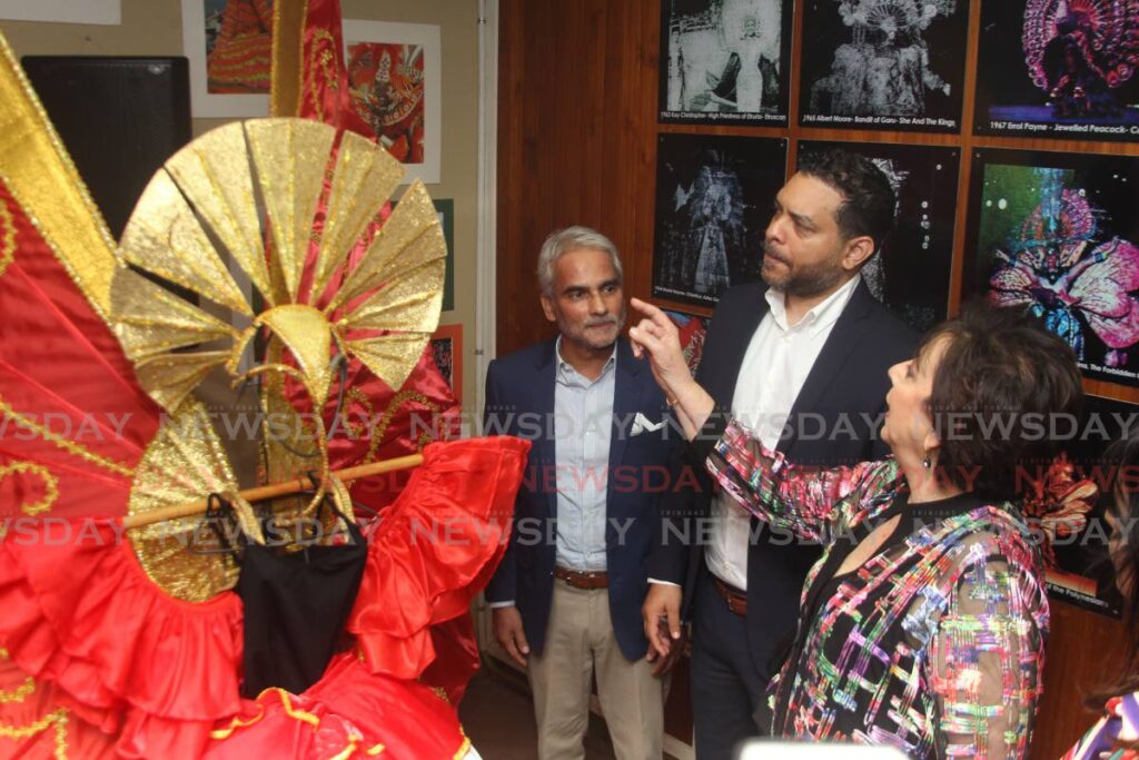 Rosalind Gabriel, of the TTCBA, right, discusses a costume with Tourism Minister Randall Mitchell and First Citizens deputy CEO Sterling Frost at the launch of the Carnival Museum at the Penny Bank Building, Port of Spain on July 27. - ROGER JACOB