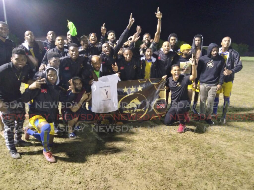 Wolf Pack FC members celebrate victory in the Sweet Sixteen Football League at the Ojoe Recreation Ground, Sangre Grande, Saturday. - Stephon Nicholas