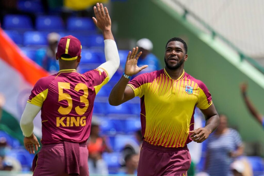 West Indies' Obed McCoy celebrates with teammate Brandon King the dismissal of India's captain Rohit Sharma during the second T20 cricket match at Warner Park in Basseterre, St Kitts, on Monday. (AP PHOTO)  