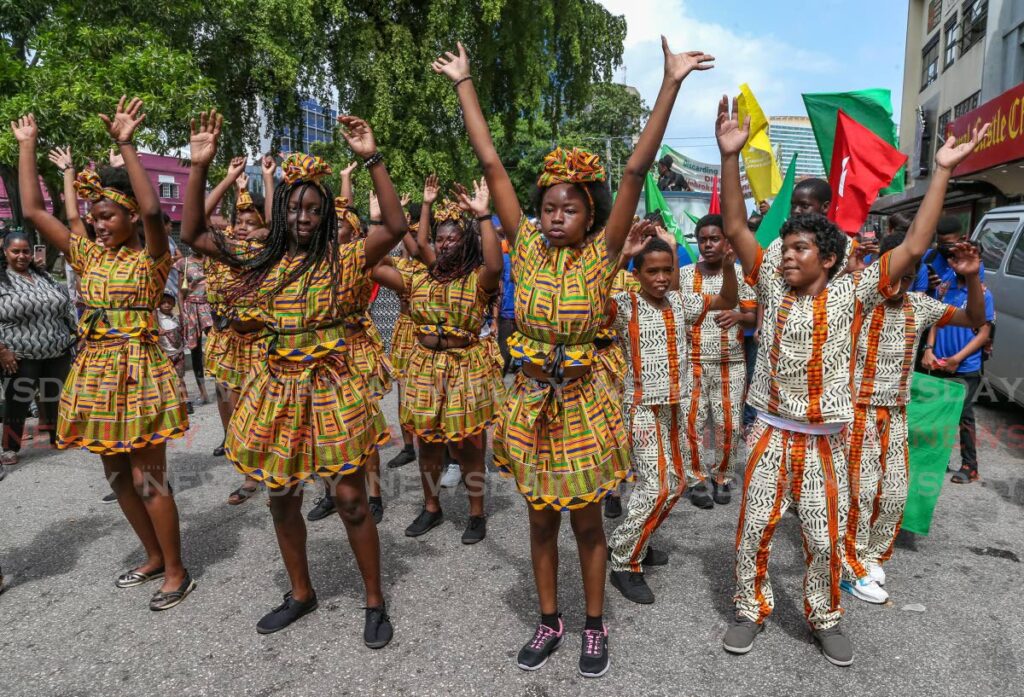 A group of dancers performs during the Kambule Procession in Port of Spain on Monday. Photo by Jeff K Mayers