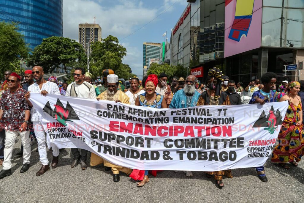 Members of the Emancipation Support Committee, the Government and the Caribbean Freedom Project lead the way for the Kambule Procession on Independence Square, Port of Spain, in celebration of Emancipation Day on Monday. Photo by Jeff K. Mayers