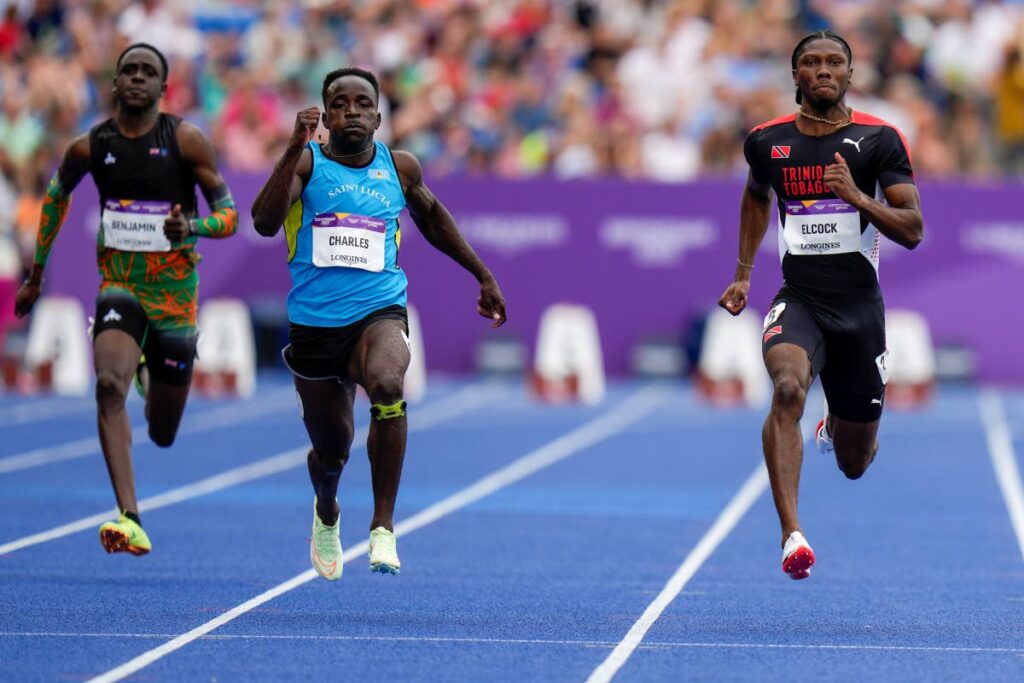 TT’s Jerod Elcock, right, competes in his men’s 100m heat during the athletics in the Alexander Stadium at the Commonwealth Games in Birmingham, England, on Tuesday. (AP Photo)