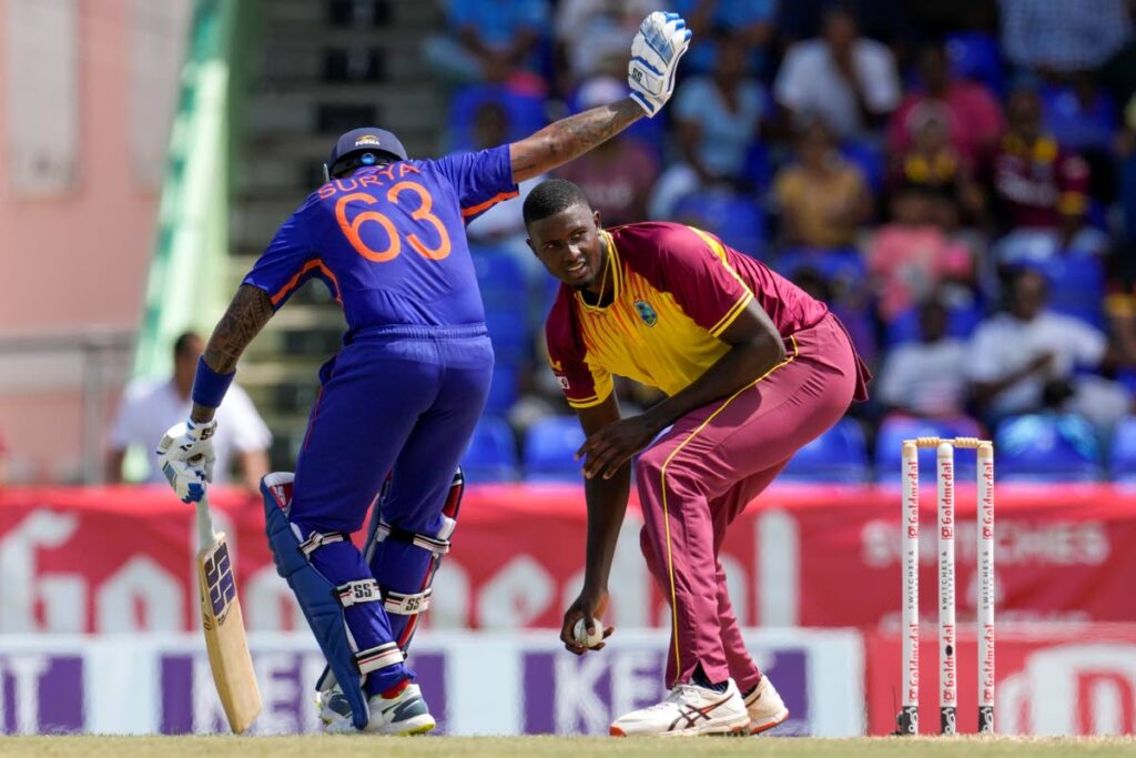 West Indies' Jason Holder fields from his own bowling as India's Suryakumar Yadav makes it to the crease during the third T20 at Warner Park in Basseterre, St. Kitts and Nevis, on Tuesday. (AP Photo) 