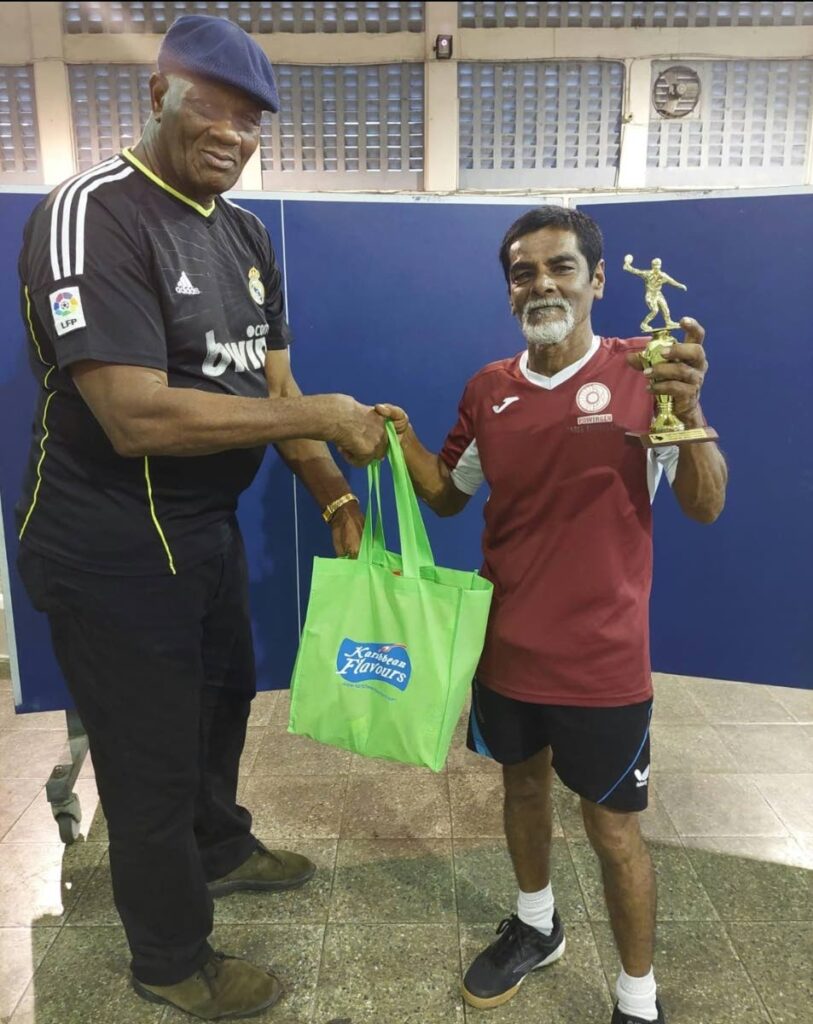 PowerGen's Faiz Mohammed, right, celebrates his 60-69 title win at the South Zone Masters table tennis tournament.  - 