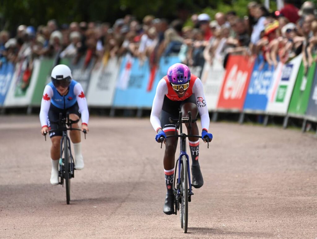 Teniel Campbell of Trinidad and Tobago, right, and Simone Boilard of Canada, left, compete in the women's cycling individual time trials during the Commonwealth Games, in Wolverhampton, England, on Thursday. (AP PHOTO) - 