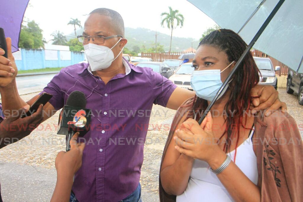 TORTUROUS WAIT: Siblings Michael and Cindy Farrell speak outside the Forensic Science Centre in St James on Thursday, about the long wait to retrieve the bodies of their mother, brother and neighbour who were chopped to death and their Guapo house set ablaze in February 2020. 
 Photo by Angelo Marcelle