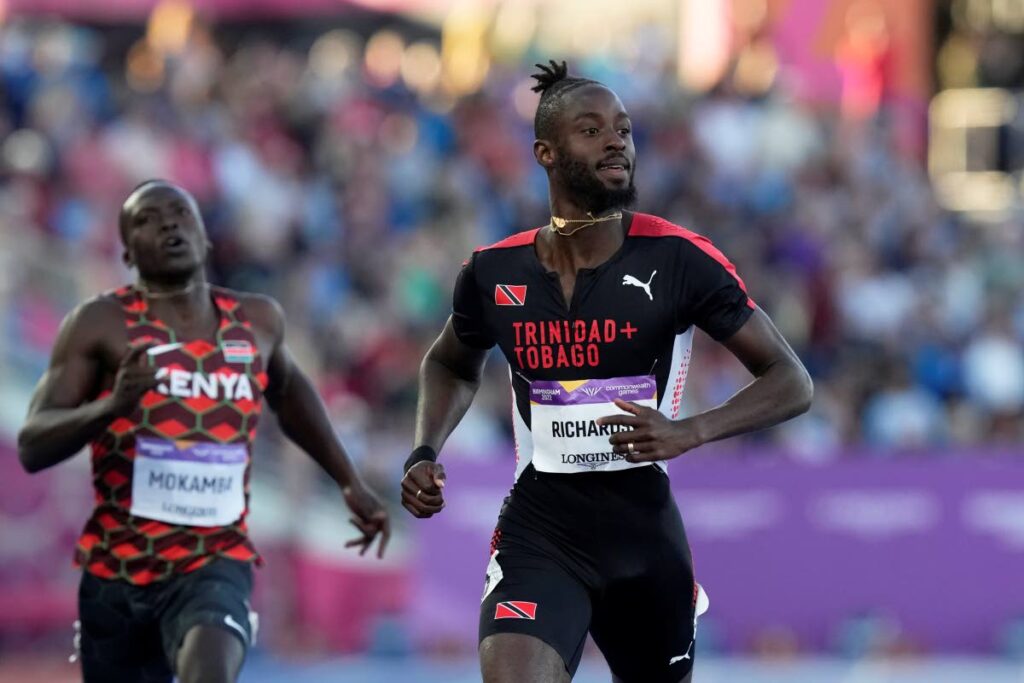 Jereem Richards of Trinidad and Tobago finishes ahead of Mike Mokamba Nyang'au of Kenya (left), in a men's 200 metres semifinal in the Alexander Stadium at the Commonwealth Games in Birmingham, England, on Friday. (AP PHOTOS) - 