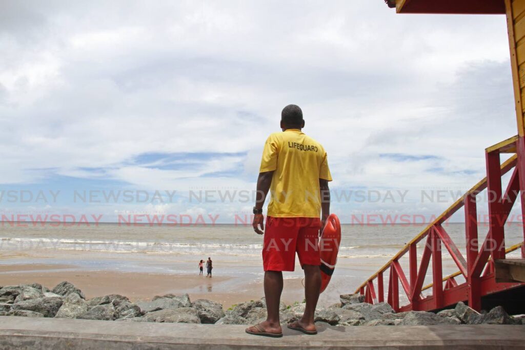 In this file photo a lifeguard keeps watch on children at Quinam beach.  