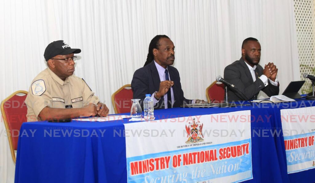 National Security Minister Fitzgerald Hinds addresses the media on Friday at his Abercromby Street, Port of Spain office. With him are acting Commissioner of Police Mc Donald Jacob and Public Utilities Minister Marvin Gonzales. Photo by Sureash Cholai